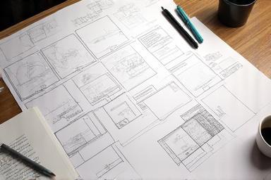 Storyboards laid out on a desk during the planning phase